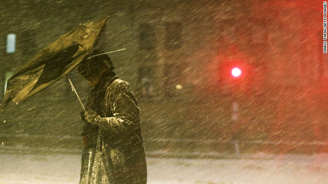 A pedestrian makes his way through driving snow with a broken umbrella in the Back Bay neighborhood on Friday, February 8 in Boston. Massachusetts as well as other states from New York to Maine are preparing for a major blizzard with possible record amounts of snowfall in some areas.