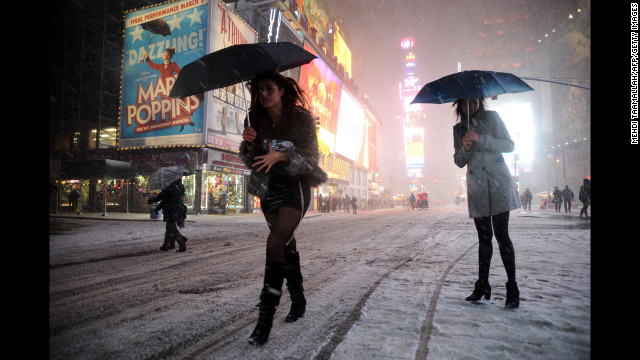 Two women look for a taxi in snow-covered Times Square on February 8.