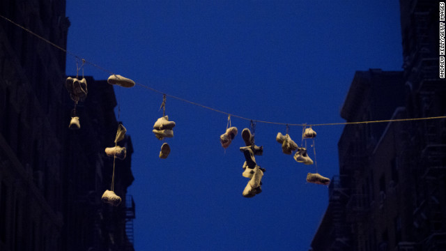 Snow gathers on shoes hung from power lines in the Lower East Side of New York City.