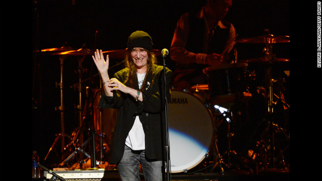 Singer Patti Smith waves to the audience during her performance of "Because the Night."