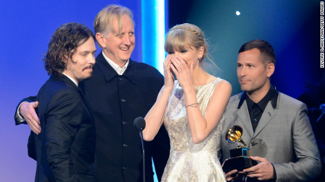 Taylor Swift accepts the Grammy award for best song written for visual media along with John Paul White and T Bone Burnett.