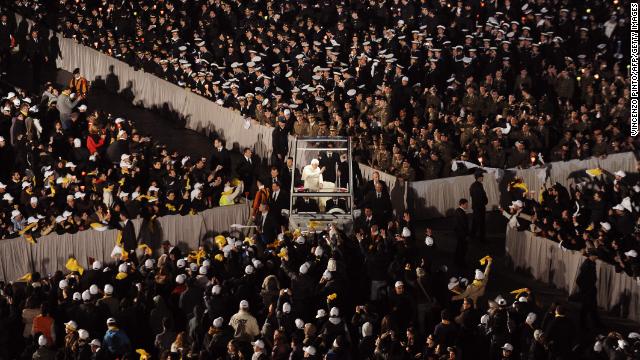 Benedict blesses pilgrims as he arrives in St. Peter's Square in his popemobile in March 2010 to meet with young people from Rome and the Lazio region in preparation for World Youth Day.