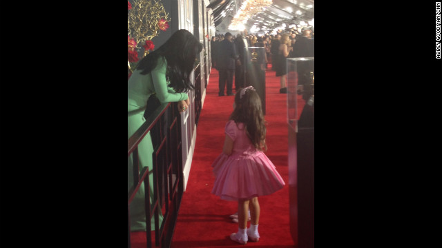 Katy Perry planned to race past the press like her BFF Rihanna, but couldn't resist stopping for a little girl talk with "The Ellen Degeneres Show's" pink princesses Sophia Grace and Rosie (obscured in photo). What do you think they're talking about?