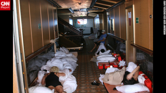 Passengers lie on beds in a hallway aboard the Carnival Triumph.