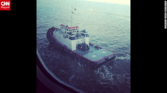 "One of two tugboats pulling us through the channel to Mobile, Alabama, along with a channel guide boat," writes Maclaskey. The ship is being towed slowly to Mobile, Alabama, and is expected to port late February 14.