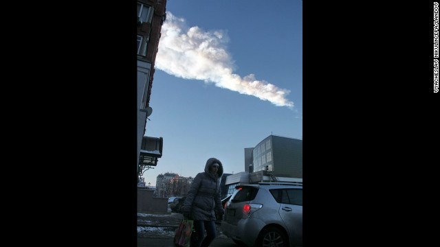 The meteor's vapor trail passes over the city. 