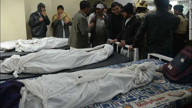 Locals gather at a morgue to identify the remains of relatives.