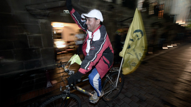 A supporter of Ecuadorian President Rafael Correa celebrates Correa's apparent re-election Sunday.