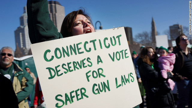  A woman's sign echoes President Obama's address to the nation at a rally for gun control at the Connecticut State Capitol on February 14.
