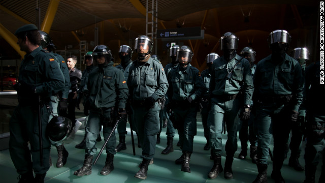 Riot Police walk forward making a cordon during a protest of Spanish Airline Iberia staff.