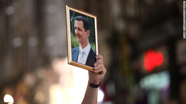 A Syrian man holds up a portrait of President Bashar al-Assad during a rally to show support for the president in Damascus on April 30, 2011.