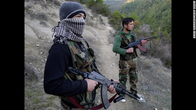 Members of the Free Syrian Army stand in an valley near the village of Ain al-Baida, close to the Turkish border, on December 15, 2011.