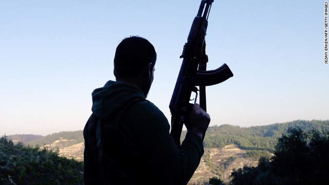 A member of the Free Syrian Army looks out over a valley in the village of Ain al-Baida on December 15, 2011.