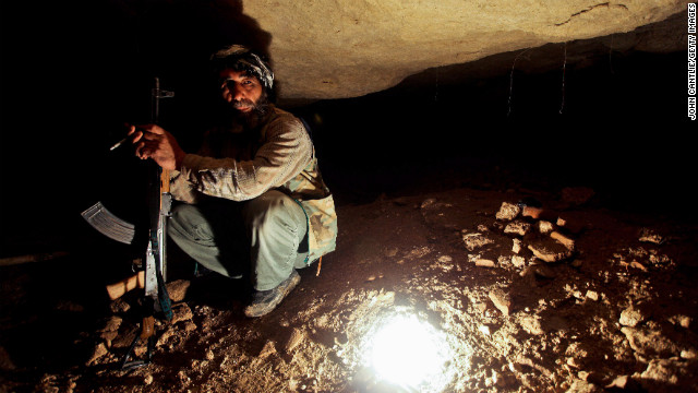 A Free Syrian Army member takes cover in underground caves in Sarmin on April 9, 2012.