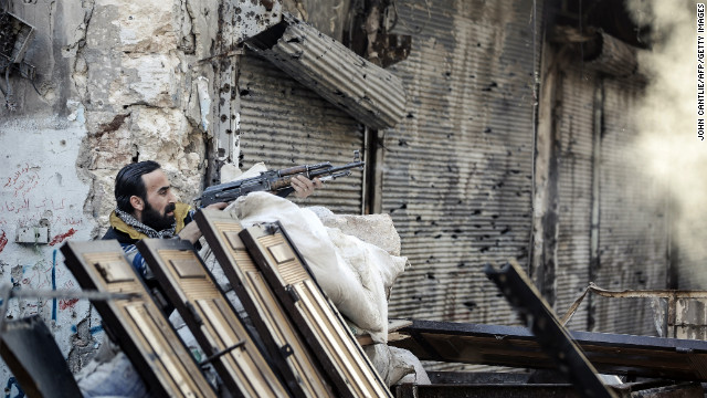 A rebel fighter fires at a Syrian government position in Aleppo on November 6, 2012.