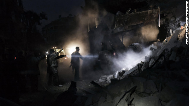 Syrians look for survivors amid the rubble of a building targeted by a missile in Aleppo on January 7.