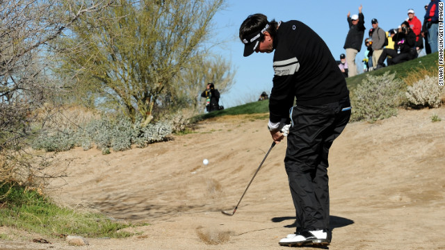 Bubba Watson tries to play his way out of trouble on the fourth hole at Dove Mountain on February 23.