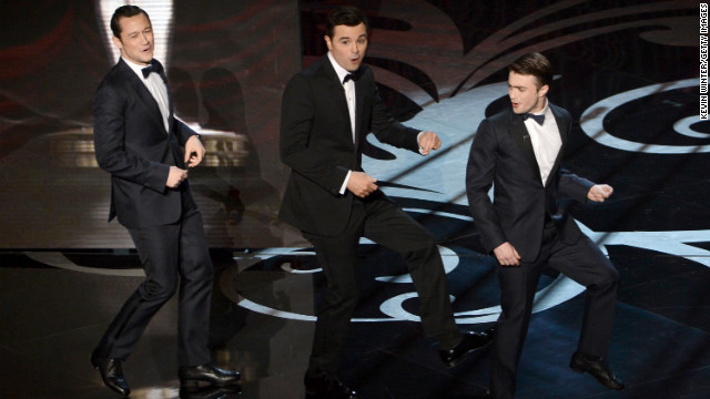 Joseph Gordon-Levitt, left, and Daniel Radcliffe, right, join MacFarlane onstage for a rendition of "High Hopes."