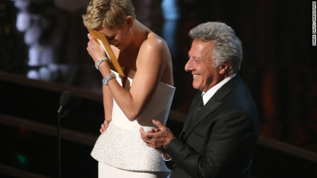 Charlize Theron blushes after Dustin Hoffman complimented her dance skills.