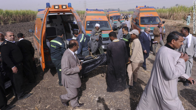 A body gets loaded onto an ambulance.