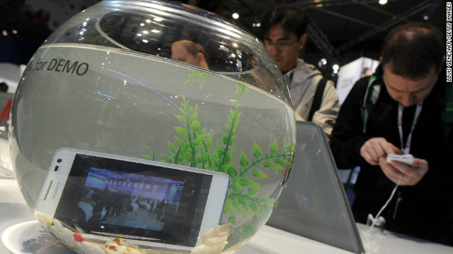 Chinese tech giant Huawei exhibits its water-resistant Ascend D2 smartphone in a fishbowl at their stand at the Mobile World Congress.