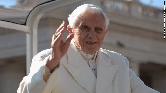 Pope Benedict XVI waves from his Popemobile.