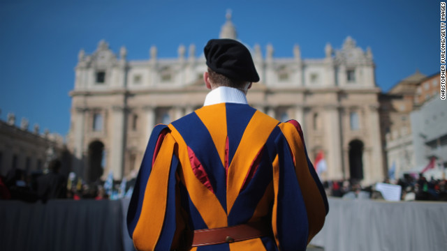 A Swiss guard stands in front of the Vatican.