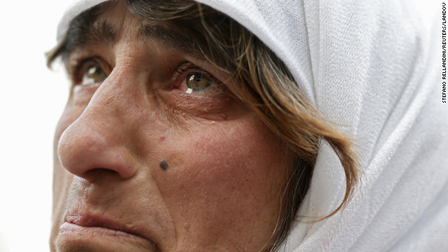 A woman watches a screen showing the departure of Pope Benedict XVI from Vatican City on February 28.