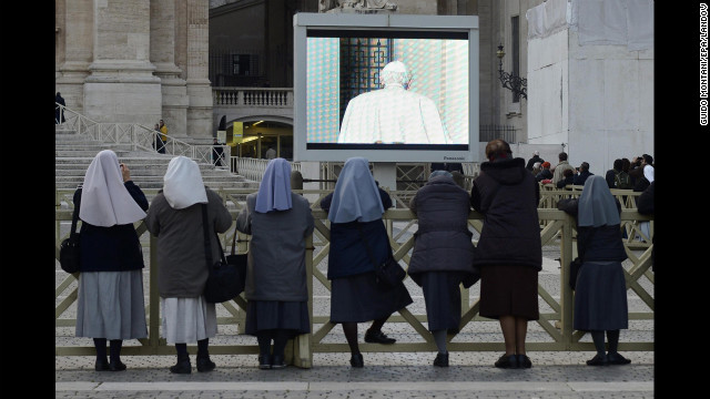 Nuns watch from Vatican City as Pope Benedict XVI leaves the balcony of the papal summer residence in Castel Gandolfo.