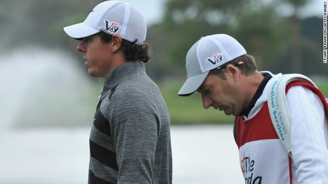 Rory McIlroy and his caddie J.P Fitzgerald walk off the course after the Northern Irish stars pulls out of the second round of the Honda Classic. 