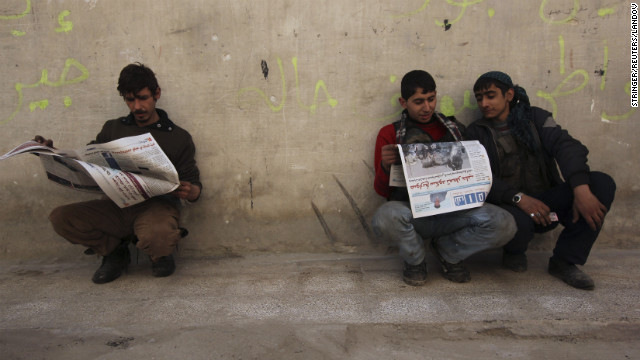 Residents read Shaam News newspapers published by the Free Syrian Army in Aleppo on March 2.