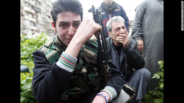 A member of the Free Syrian Army reacts to the death of a comrade who was killed in fighting, at Bustan al Qasr cemetery in Aleppo on Friday, March 1.