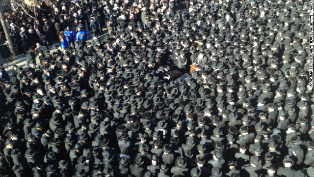 Mourners attend the funeral for Raizel Glauber and her husband, Nathan Glauber, in Brooklyn, on Sunday. 