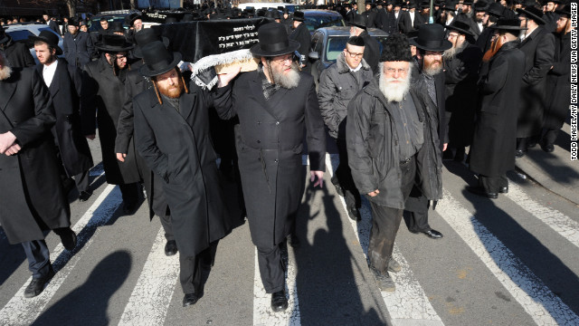 Men carry the coffins of the young couple through the streets of Williamsburg, Brooklyn, on Sunday. 