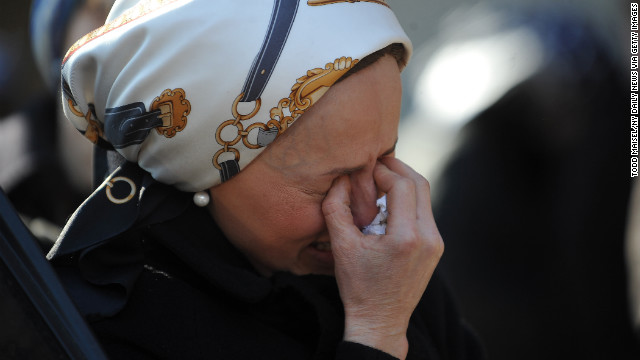 A woman cries during the funeral. 