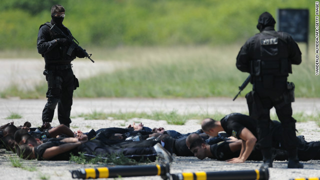 Police commandos from an anti-kidnapping unit, arrest and control a group of 'terrorists' during a drill at the Tom Jobim International Airport in Rio de Janeiro, Brazil, on January 13, 2012.