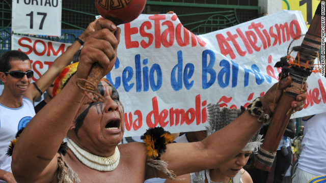 People chant slogans during a protest against the demolition of the Celio de Barros track and field stadium in Rio de Janeiro, Brazil on January 13, 2013. The stadium needs to be demolished to carry out the Maracana stadium construction plans ahead of the 2013 FIFA Confederations Cup, 2014 FIFA World Cup and 2016 Olympic games.