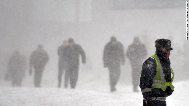 A traffic police officer patrols during heavy wind and snowfall in Kiev, Ukraine, on March 4.