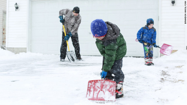 Left to right: Anthony Jordan and his 6-year-old twin sons Griffin and Landin shovel their driveway in Sycamore, Illinois, on March 5. 