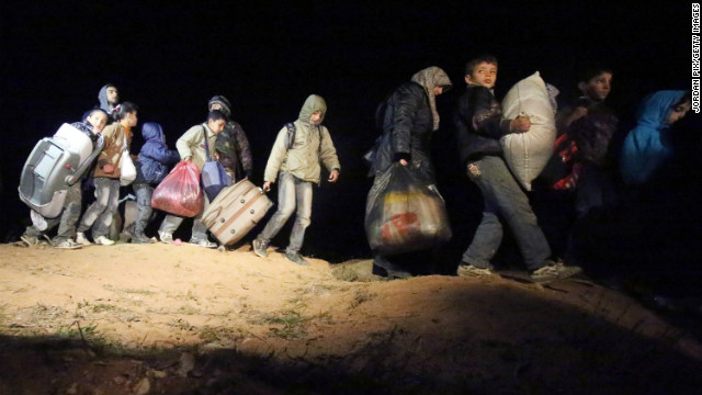 Refugees fleeing the conflict in Syria arrive February 18 at the Jordanian border. 