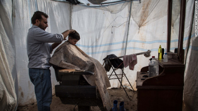 A refugee child gets a haircut at a makeshift barbershop at the Azaz refugee camp on February 19.