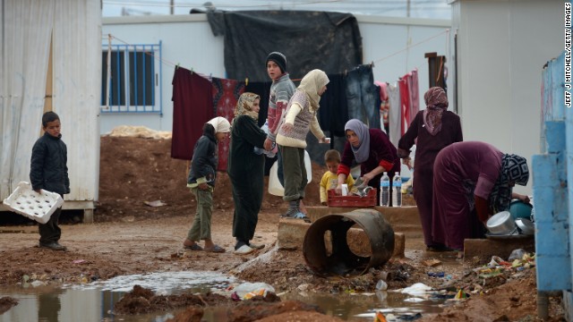 Syrian children gather around women washing in the Zaatari refugee camp on January 31.