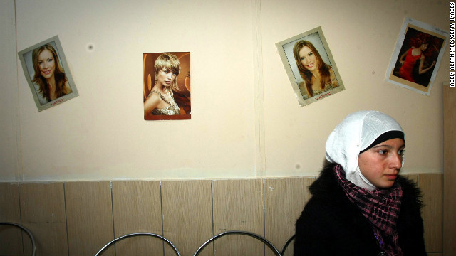 A Syrian refugee waits November 27, 2012, at a hairdresser's shop, where refugees can also receive training, inside the Oncupinar camp in Kilis, southern Turkey.