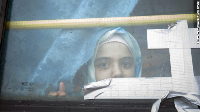 A Syrian girl looks through the window of a bus where she has lived with her family for the past eight months at a refugee camp in Bab al-Salam on the Syria-Turkey border on February 28.