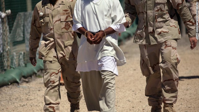 U.S. military guards move a detainee inside the detention center in September 2010. At its peak, the detainee population exceeded 750 men at Guantanamo.