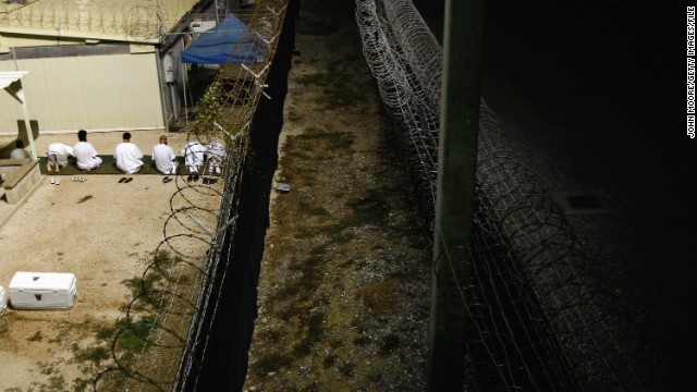 Muslim detainees kneel during early morning prayers in October 2009. Cells are marked with an arrow pointing in the direction of Mecca, regarded as Islam's holy city.