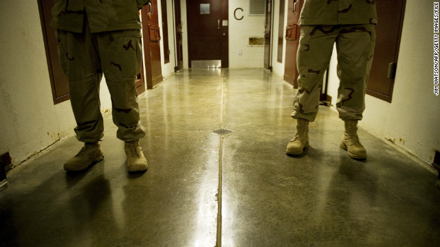 Members of the U.S. Navy move down the hallway of Cell Block C in the Camp 5 detention facility in January 2012.