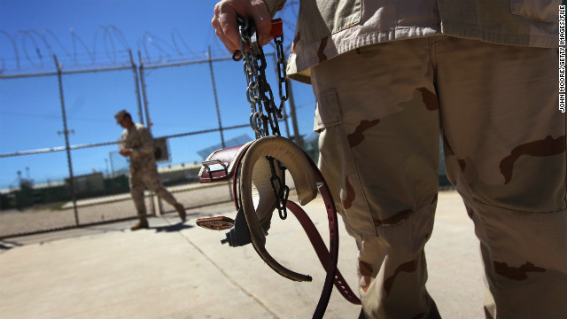 A U.S. military guard holds shackles before preparing to move a detainee in September 2010.