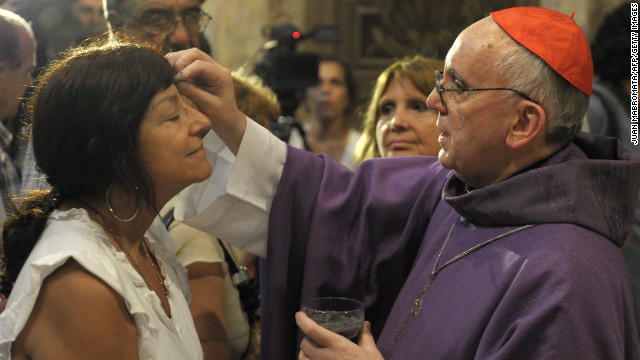 Bergoglio, right, draws the cross on the forehead of a parishioner during a Mass for Ash Wednesday, which begins the 40-day period of abstinence for Christians before the Holy Week and Easter, on February 13 at the Metropolitan Cathedral in Buenos Aires.