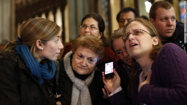 Florencia Silva, right, of Trumbull, Connecticut, and Valentina Bruner of Peru tune in to a webcast of newly elected Pope Francis at St. Patrick's Cathedral in New York.